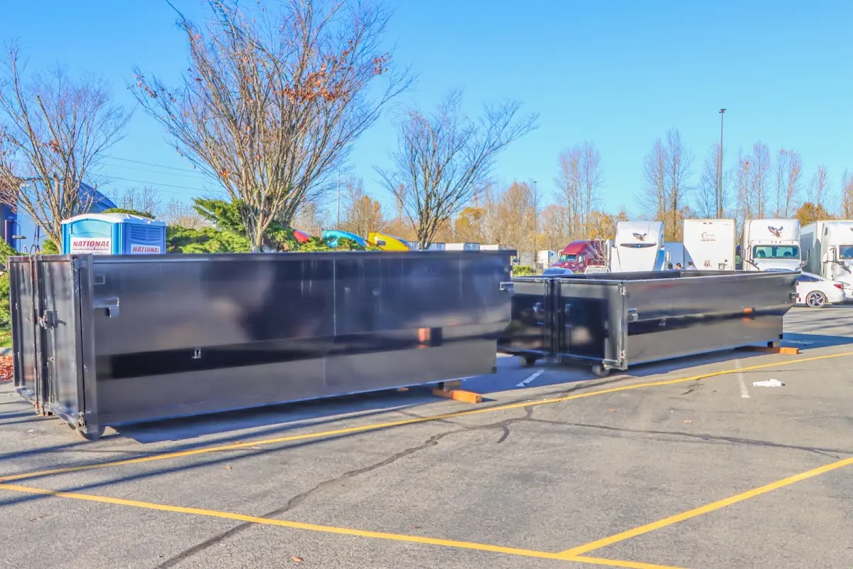 Professional dumpster rental service with roll-off container on residential driveway in Cherokee